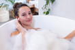 © Wavebreak Media - Relaxing in bathtub with foam, woman enjoying spa treatment at home