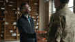 © Yuliia - Psychotherapy session appointment meeting mature Caucasian man male psychologist businessman greeting shaking hands handshake officer in camouflage uniform military army soldier veteran indoor office