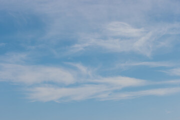 The baby blue sky with wispy clouds over Lake Michigan off the coast at Harrington Beach State Park, Belgium, Wisconsin in the warm morning of mid-September