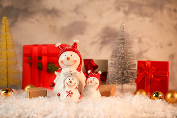 Wall Mural - Funny snowmen figures and Christmas decor on artificial snow