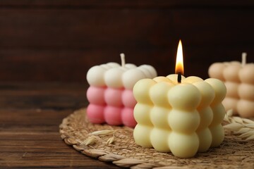 Poster - Different stylish bubble candles on wooden table, closeup. Space for text