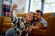 © Drazen - Happy couple taking selfie at home.