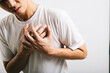 © sorapop - Portrait Asian young man holding his arms around his chest suffering because of a heart attack studio isolated white background, Happy lifestyle men chest pain health discomfort heart problems