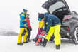 © william87 - Group of friends getting ready for snowboarding at ski resort parking