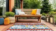 © LIPO@SEXTAO22 - Small patio with a simple wooden bench, a colorful outdoor rug, and lanterns