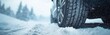 © monvideo - Winter tires navigate through deep snow on a cold road in a serene landscape