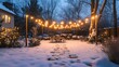 © Terablete - Winter evening in a snow-covered backyard adorned with string lights and holiday decorations