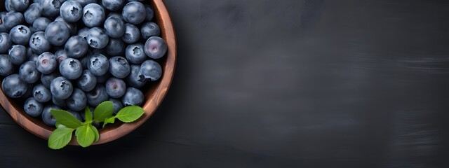 Fresh Blueberries in Wooden Bowl on Dark Background