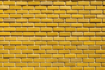 Wall Mural - Close-up of yellow brick wall with textured surface