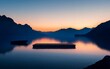 © GoDesigner - A wooden dock sits on a still lake at sunrise with a mountain backdrop.