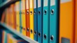 © kept - Image of colorful office binders on a shelf, offering a vibrant and organized look.