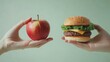 © Business Pics - One hand holding apple fruit, other holding hamburger. Healthy natural organic fresh vegetarian food vs unhealthy processed fast junk food meat. Nutrition diet lifestyle, fitness eating choice