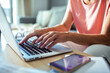 © Marko Geber - Senior woman managing finances on laptop at home