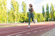 © Dexon Dee - Sporty woman running on athlete track