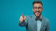 © Ace64 Studio - Portrait of cheerful businessman pointing at copy space for advertising against blue background.