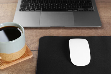 Sticker - Computer mouse with mousepad, cup of coffee and laptop on wooden table