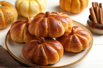 Sticker - Tasty pumpkin shaped buns and ingredients on white wooden table, closeup