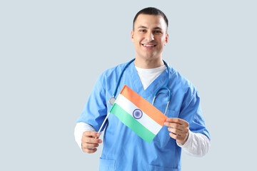 Sticker - Male doctor with flag of India on grey background. National Doctor's Day celebration