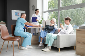 Canvas Print - Group of doctors with apples studying x-ray image in clinic