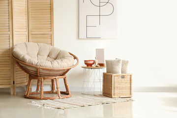 Poster - Interior of cozy living room with armchair and wooden folding screen