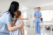 © Pixel-Shot - Mother and female osteopath working with little patient in clinic