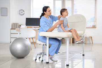 Poster - Female osteopath working with little patient in clinic