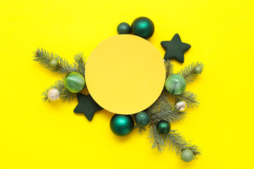 Wall Mural - Composition with blank card, beautiful Christmas balls and fir branches on yellow background