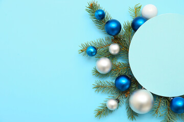 Wall Mural - Composition with blank card, beautiful Christmas balls and fir branches on blue background