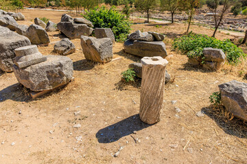 A large pile of rocks and a small stone pillar. Ruins of the ancient city of Philippi, Greece