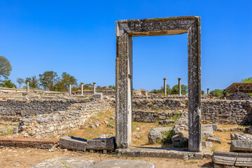 A large stone archway is the focal point of the scene. Ruins of the ancient city of Philippi, Greece