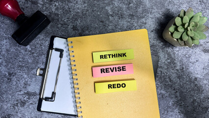 Concept of Rethink, Revise, Redo write on sticky notes isolated on Wooden Table.