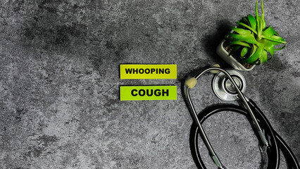 Wall Mural - Concept of Whooping Cough write on sticky notes isolated on Wooden Table.