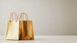 © FACTORY GRAPHICA  - Gold paper shopping bags on a table.