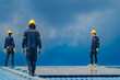 © ultramansk - Worker Technicians are working to construct solar panels system on roof. Installing solar photovoltaic panel system. Men technicians walking on roof structure to check photovoltaic solar modules.