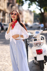 Sticker - Young woman in stylish sunglasses on city street