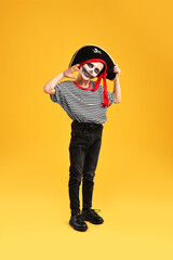 Canvas Print - Funny boy dressed like pirate on yellow background. Halloween costume