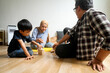 © Queenmoonlite Studio - Happy Asian Family Having Fun Together. Mother And Father With Little Boy Playing Wooden Block Tower at Home