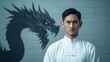 © tonpreecha - A young Asian man stands in Kung Fu gear, his stance ready for battle, his gaze sharp as the faint shadow of a dragon appears behind him, symbolizing his immense power