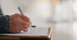 © WesLens/peopleimages.com - Senior person, hands and signature on will in home, insurance paperwork and plan for title deed. Fingers, filing report and legal compliance in agreement on table, writing and form for testament