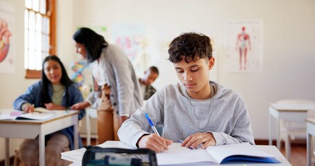 Canvas Print - Boy, student and writing with book in classroom for education, learning or exam at school. Young, male person or teenager with moderator, educator or notebook for test, assignment or assessment