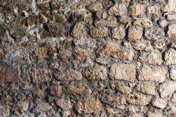 Wall Mural - Old stone wall made of rough yellow blocks, background texture