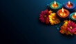© sirirat - Colorful clay diya lamps with flowers on dark background, Diwali concept, Hindu festival of lights celebration. copyspace