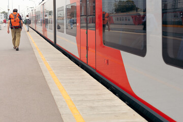 Wall Mural - Rear view of a walking man at the railway station before his trip  highway train waiting for departure