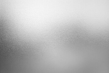 bright grainy metallic silver gradient aluminum foil texture abstract blurred monochrome background with blank space