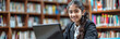 © TakoyakiAI - Indian Student Girl Studying in Library with Laptop