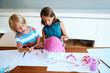 © StarDweller/peopleimages.com - Painting, children and project in home for creativity, fun activity and design for arts and crafts. Messy, kids and creative on table for paper mache, DIY piggy bank and relationship development