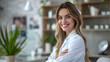 © SS Digital - Portrait of happy young smiling woman cosmetologist or beautician doctor sitting at desk in beauty spa salon office on her workplace and looking cheerful at camera. Cosmetology