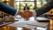 © Yada - Businessmen shaking hands after a deal.