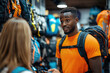 © syhin_stas - A man and a woman of African descent look for equipment for a mountain hike in a sporting goods store