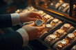 © syhin_stas - Elegant businessman admiring luxury watches in a store, showcasing a gold timepiece. Close-up highlights the intricate details of the expensive watch, representing affluence and style